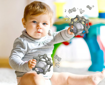 MCGMITT Teether Ball silikónové hryzadlo s hrkálkou 8,5 x 10 cm